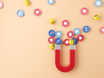 Red U-shaped magnet pulling in circular social media icons showing hearts, smiley faces and stars